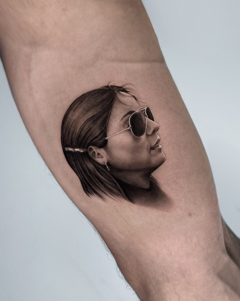 Retrato microrealista de mujer con gafas de sol en brazo interior